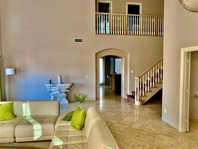 living room featuring a high ceiling