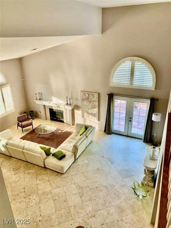 living room featuring a high ceiling and french doors