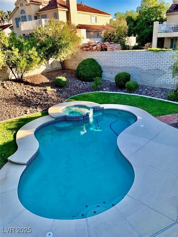 view of swimming pool with an in ground hot tub