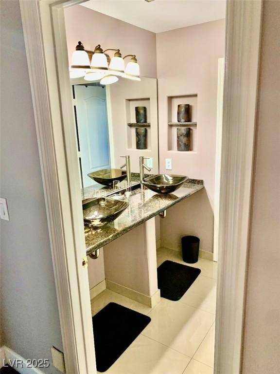 bathroom featuring tile patterned flooring and sink