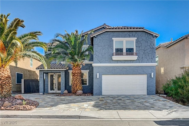 mediterranean / spanish home featuring french doors and a garage