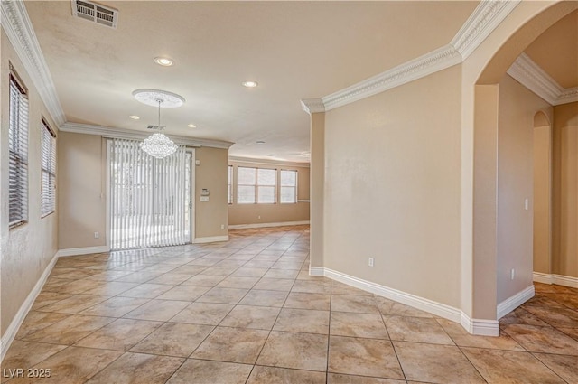 tiled spare room featuring crown molding and a chandelier