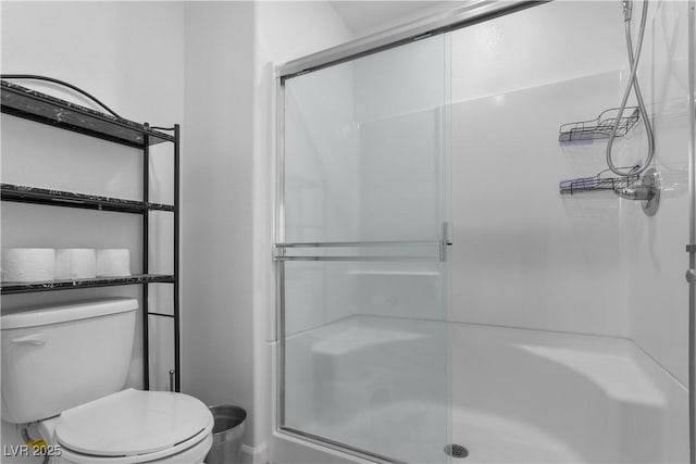 bathroom with toilet and walk in shower