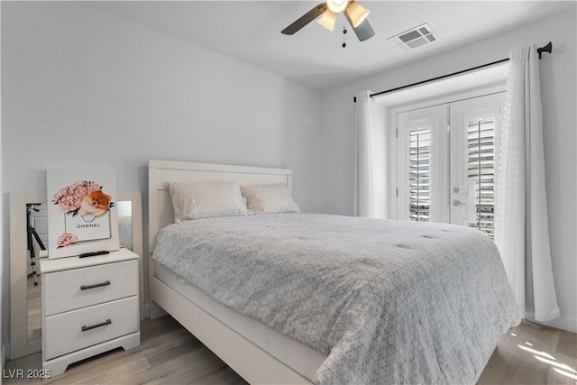 bedroom featuring ceiling fan, access to exterior, and wood-type flooring