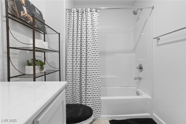 full bathroom featuring toilet, vanity, tile patterned flooring, and shower / bath combination with curtain