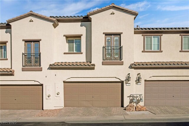 mediterranean / spanish-style house with a garage