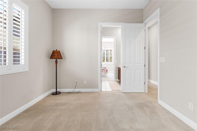 unfurnished room with light carpet