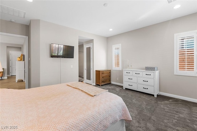 carpeted bedroom featuring multiple windows