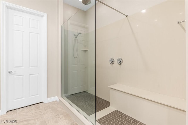 bathroom featuring tile patterned floors and tiled shower