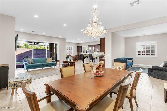 tiled dining space featuring a chandelier