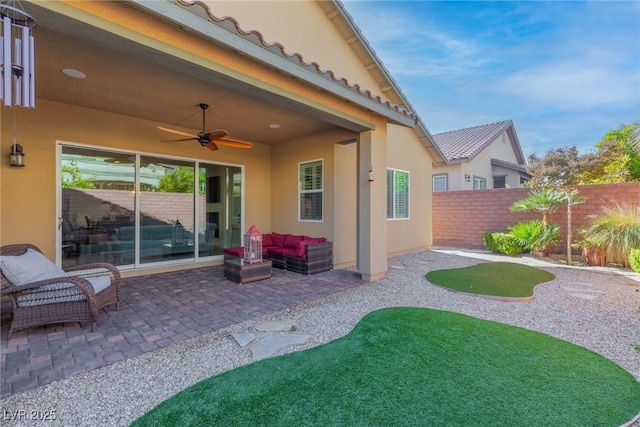 view of patio with ceiling fan and an outdoor living space