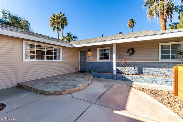 view of exterior entry featuring a patio area