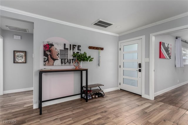 entrance foyer featuring crown molding and hardwood / wood-style flooring