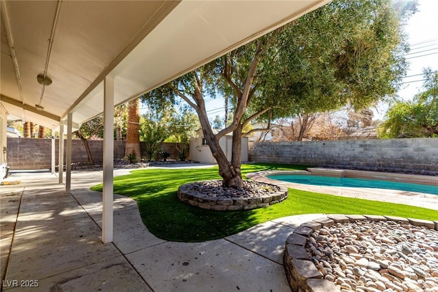 exterior space with a fenced in pool and a patio area