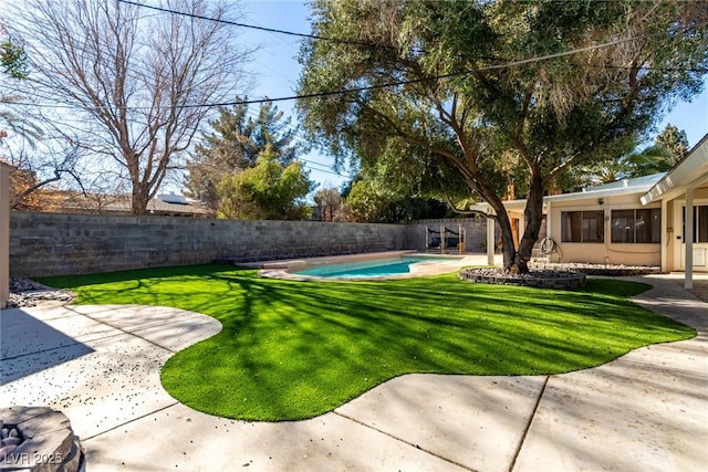 view of yard with a patio area and a fenced in pool