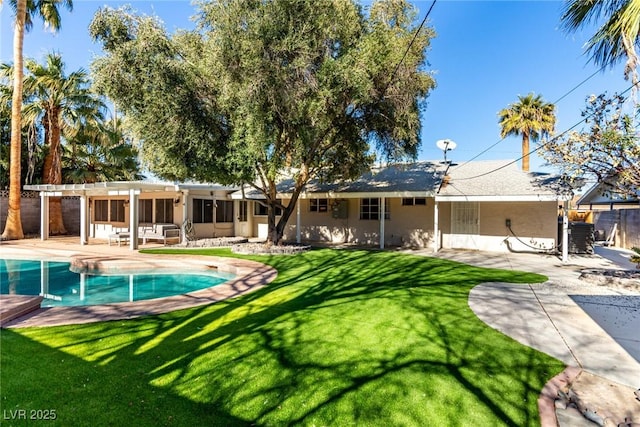 rear view of house featuring a patio area, a lawn, and a pergola