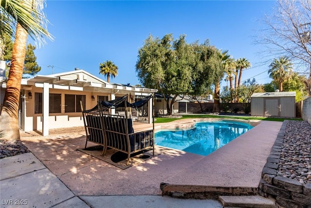 view of pool featuring a pergola, a shed, and a patio