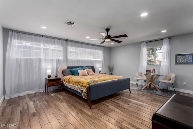 bedroom with ceiling fan and hardwood / wood-style floors