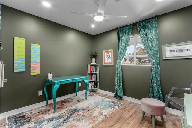 home office featuring ceiling fan and light hardwood / wood-style floors