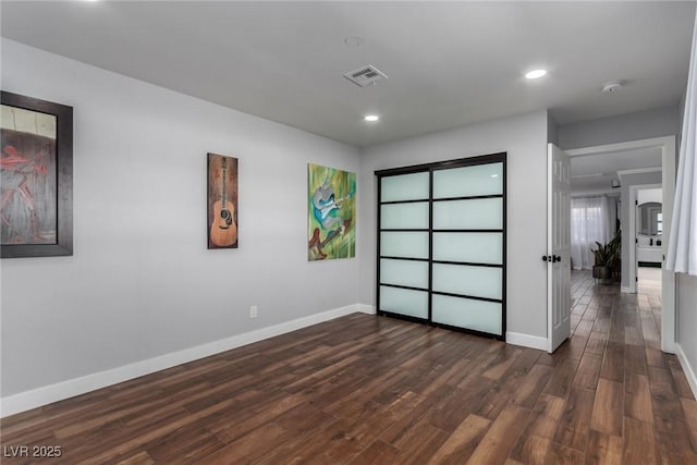 unfurnished bedroom featuring dark hardwood / wood-style flooring