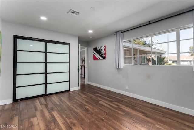 unfurnished bedroom featuring dark hardwood / wood-style flooring