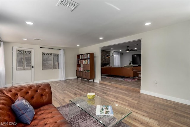 living room featuring ceiling fan and hardwood / wood-style floors