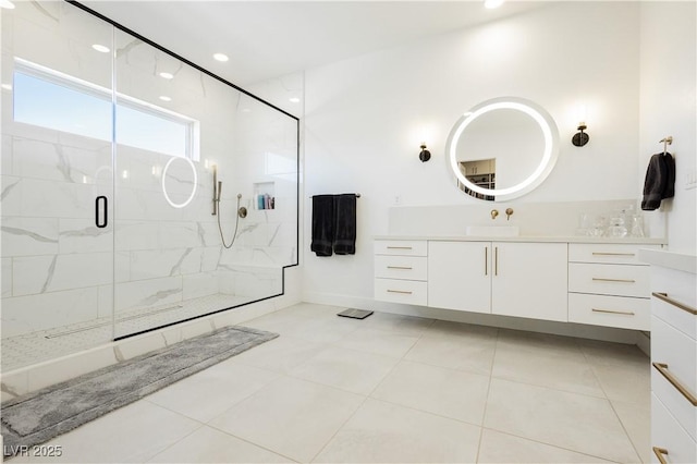 bathroom with vanity and a shower with door