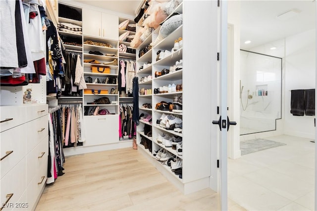 walk in closet featuring light hardwood / wood-style floors