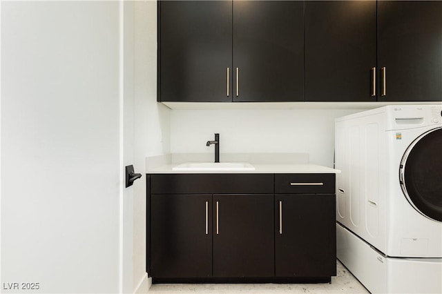 clothes washing area featuring cabinets, washer / clothes dryer, and sink