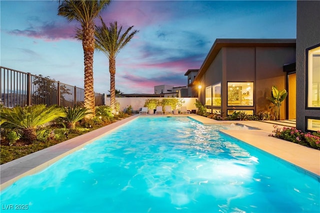 view of pool at dusk