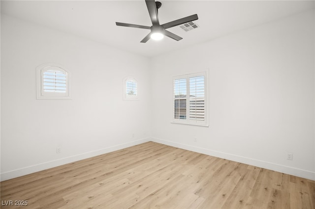 spare room with ceiling fan and light wood-type flooring