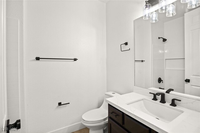 bathroom with a shower, toilet, and vanity