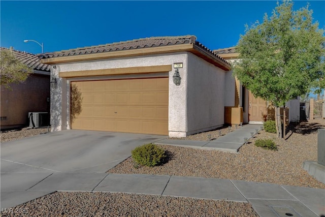 view of front of property featuring central air condition unit and a garage