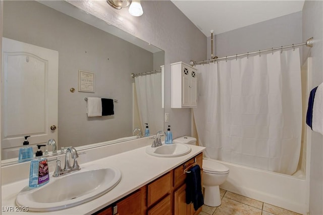 full bathroom featuring shower / bath combo with shower curtain, tile patterned floors, vanity, and toilet