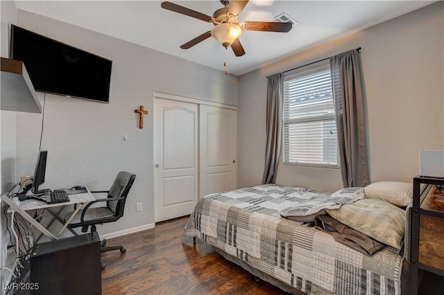 bedroom with ceiling fan, dark hardwood / wood-style floors, and a closet