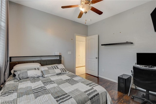 bedroom featuring ceiling fan and dark wood-type flooring