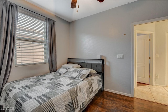 bedroom with ceiling fan and dark hardwood / wood-style flooring