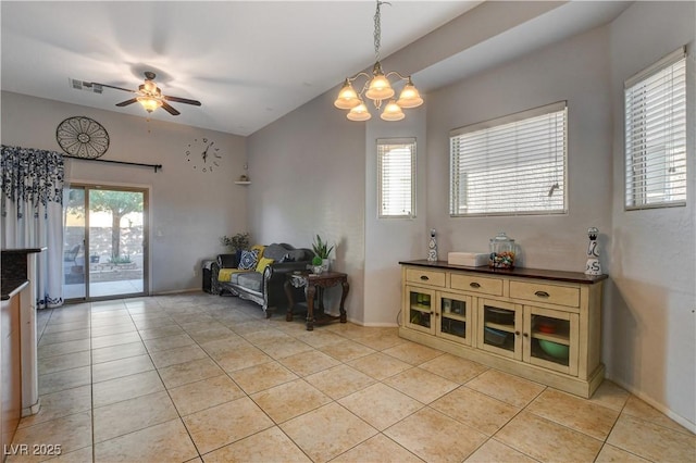 interior space featuring ceiling fan with notable chandelier and light tile patterned flooring