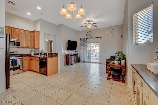 kitchen with stainless steel appliances, light tile patterned flooring, hanging light fixtures, ceiling fan with notable chandelier, and sink