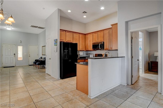 kitchen featuring decorative light fixtures, kitchen peninsula, black fridge with ice dispenser, and light tile patterned flooring