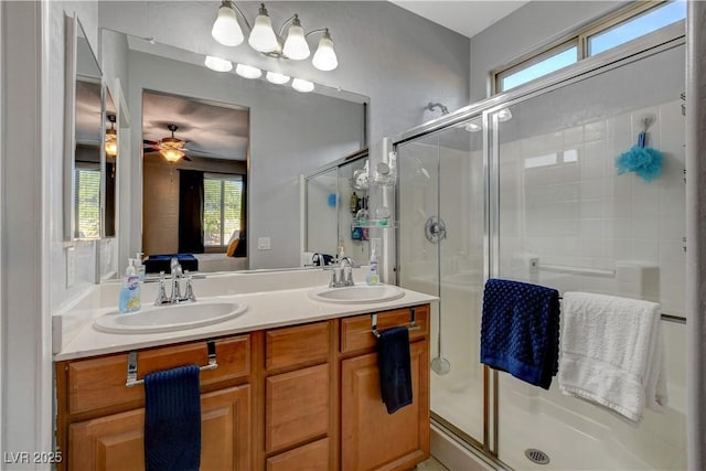 bathroom with ceiling fan, an enclosed shower, and vanity