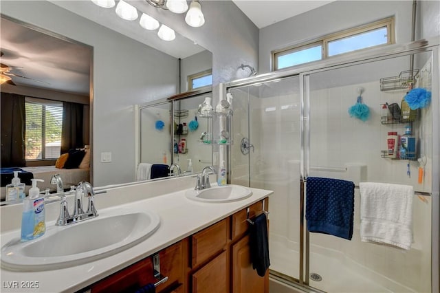 bathroom featuring vanity, ceiling fan, and a shower with door