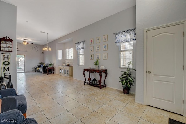 tiled living room with ceiling fan and plenty of natural light