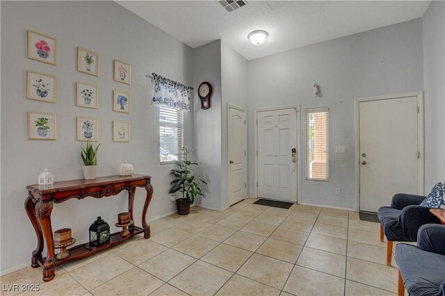 foyer entrance featuring light tile patterned flooring