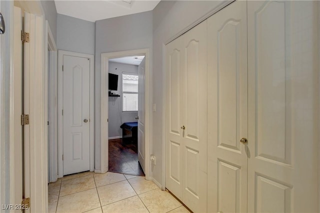 corridor with light tile patterned flooring