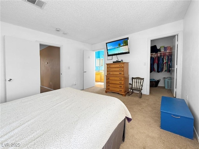 3350 Stacey Lyn Dr, Las Vegas, NV 89117 - carpeted bedroom featuring ensuite bath, a closet, a walk in closet, and a textured ceiling