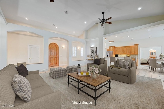 living room with ceiling fan, light tile patterned floors, and high vaulted ceiling