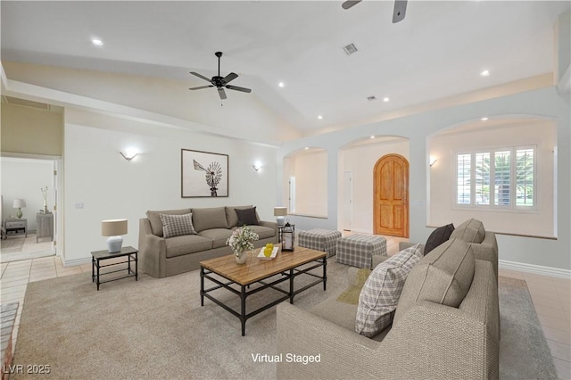 tiled living room featuring ceiling fan and vaulted ceiling