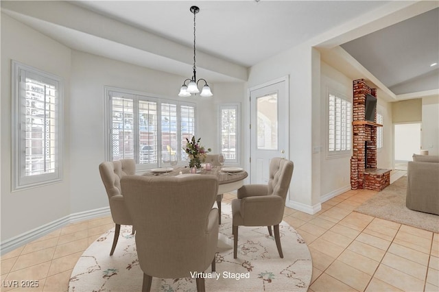 dining space with a wealth of natural light, light tile patterned flooring, and a chandelier