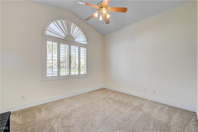 empty room featuring ceiling fan, light carpet, and vaulted ceiling